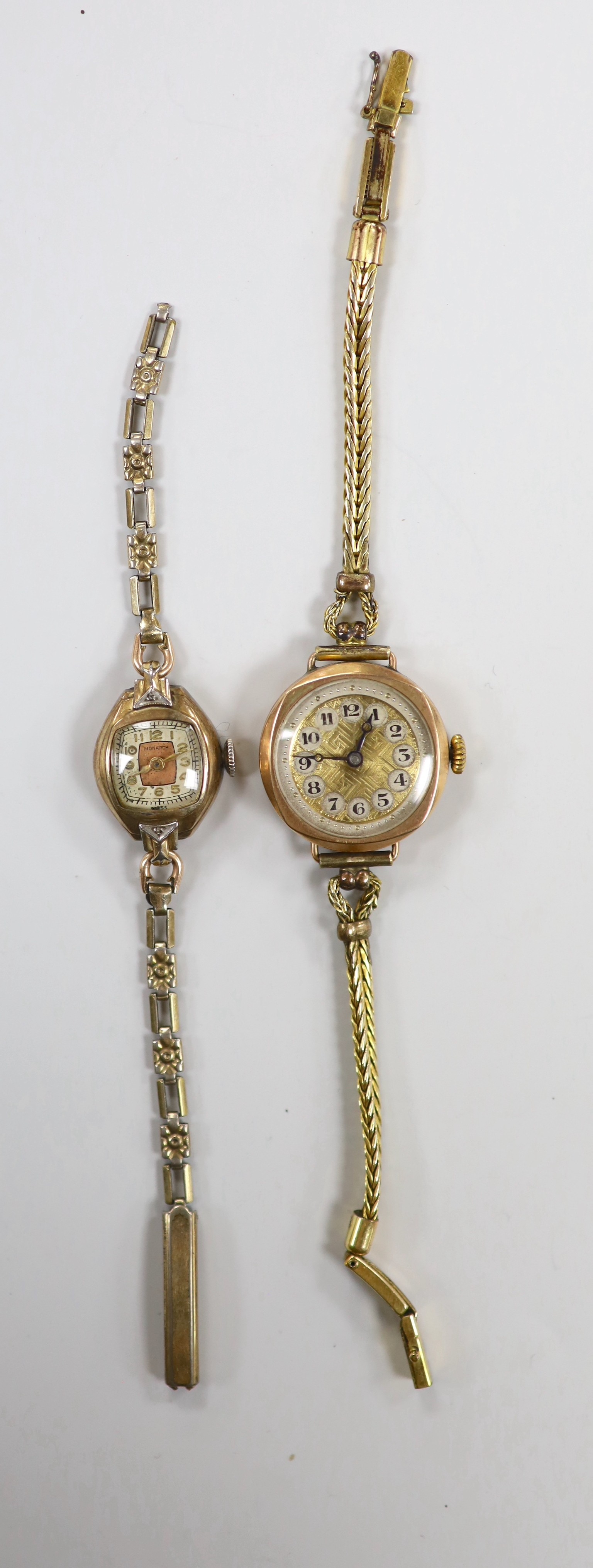 A lady's early 20th century 9ct gold manual wind wrist watch, on a gold plated bracelet and a lady's 10k gold filled Monarch manual wind wrist watch, on gold plated bracelet.